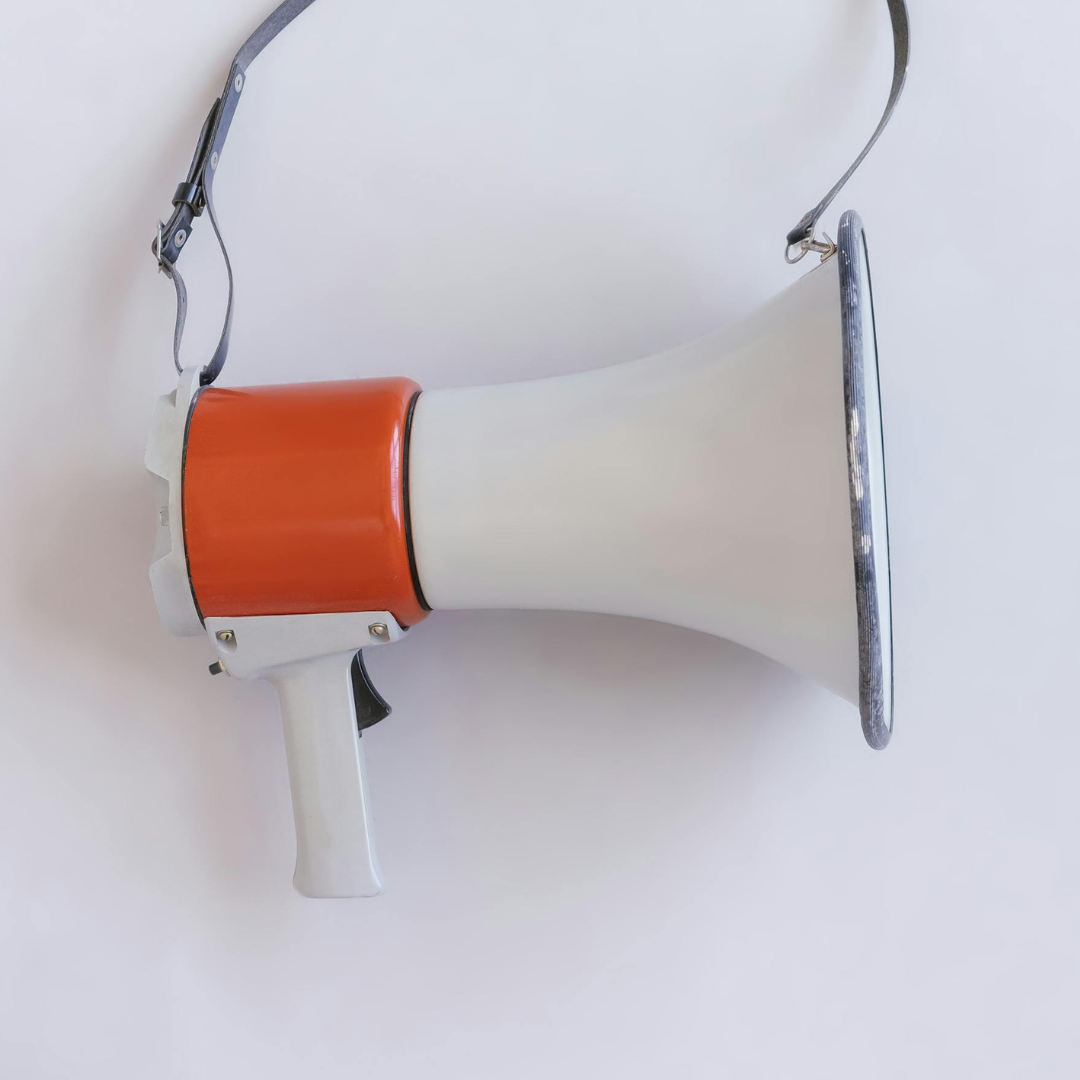 Megaphone hanging on a white wall