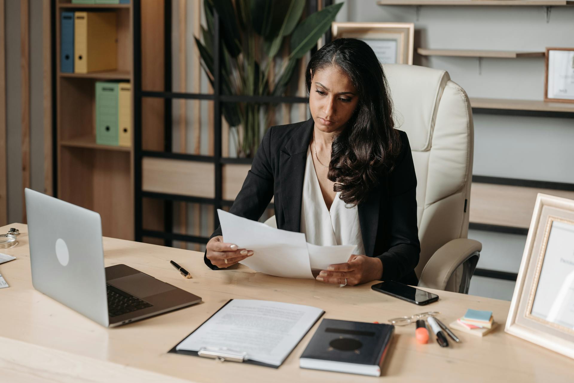 Professional woman at her desk reading through documents